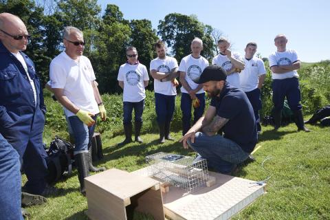 group looking at mink raft