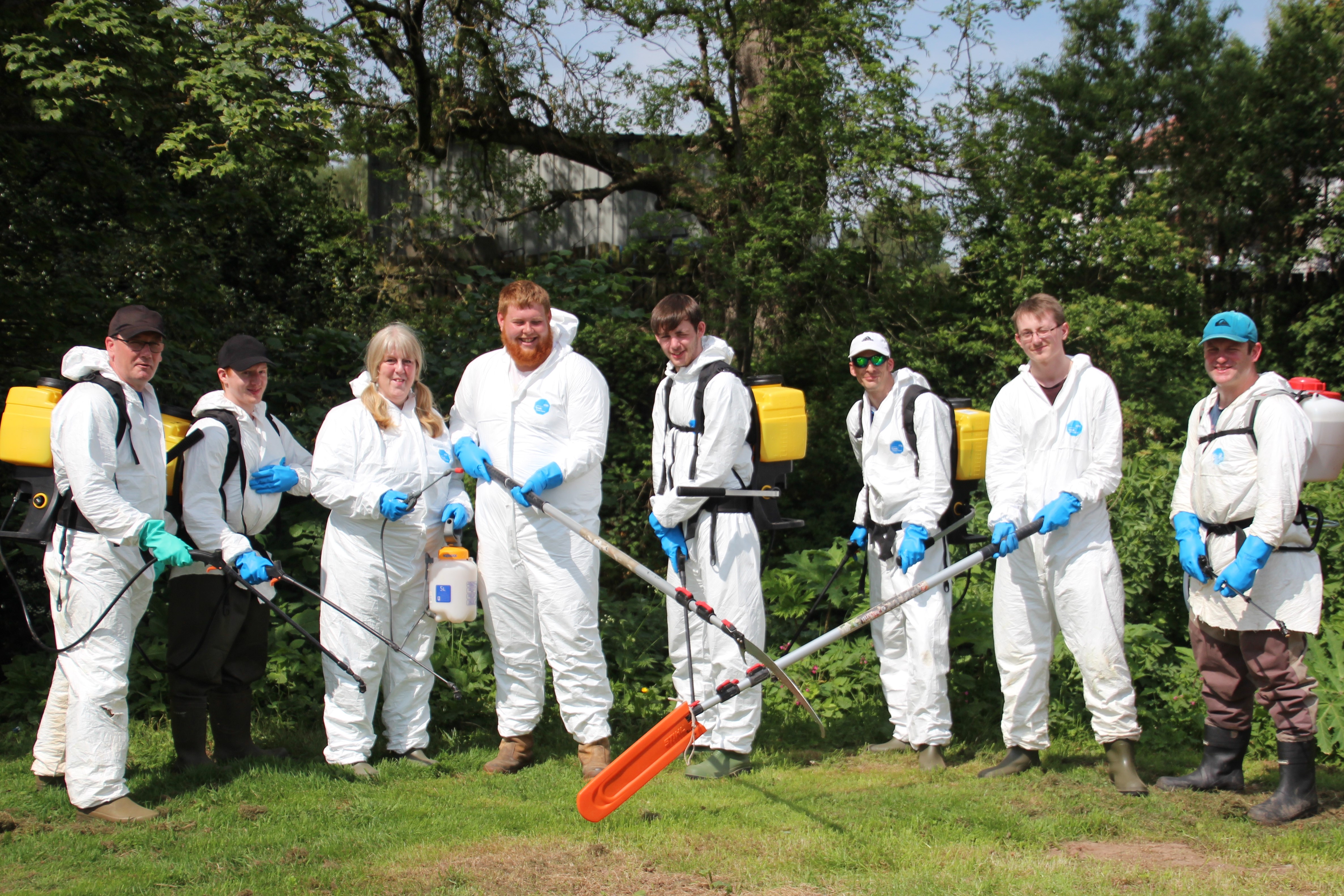 Group of volunteer with equipment to tackle giant hogweed