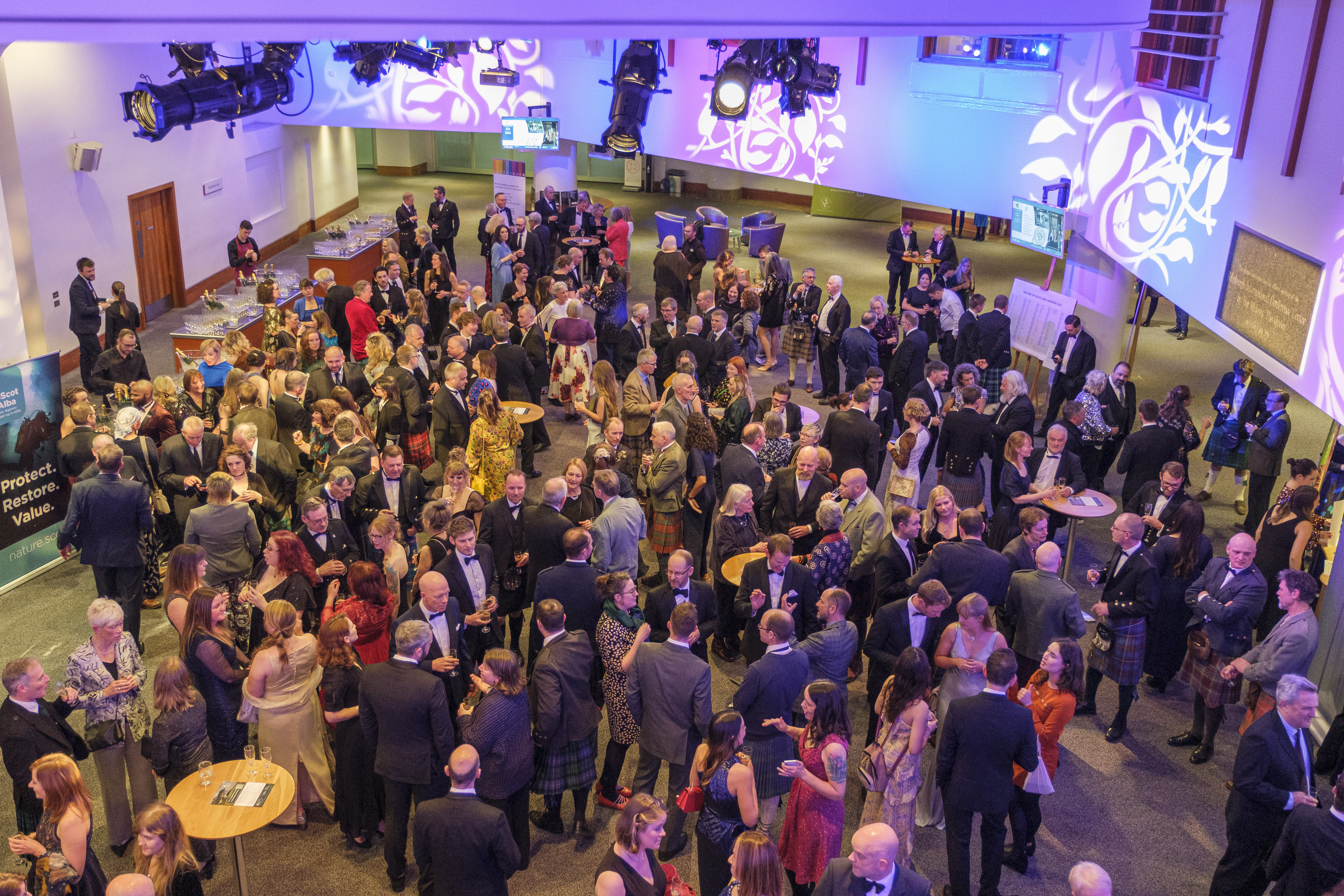 A large group of people mingling in the conference centre