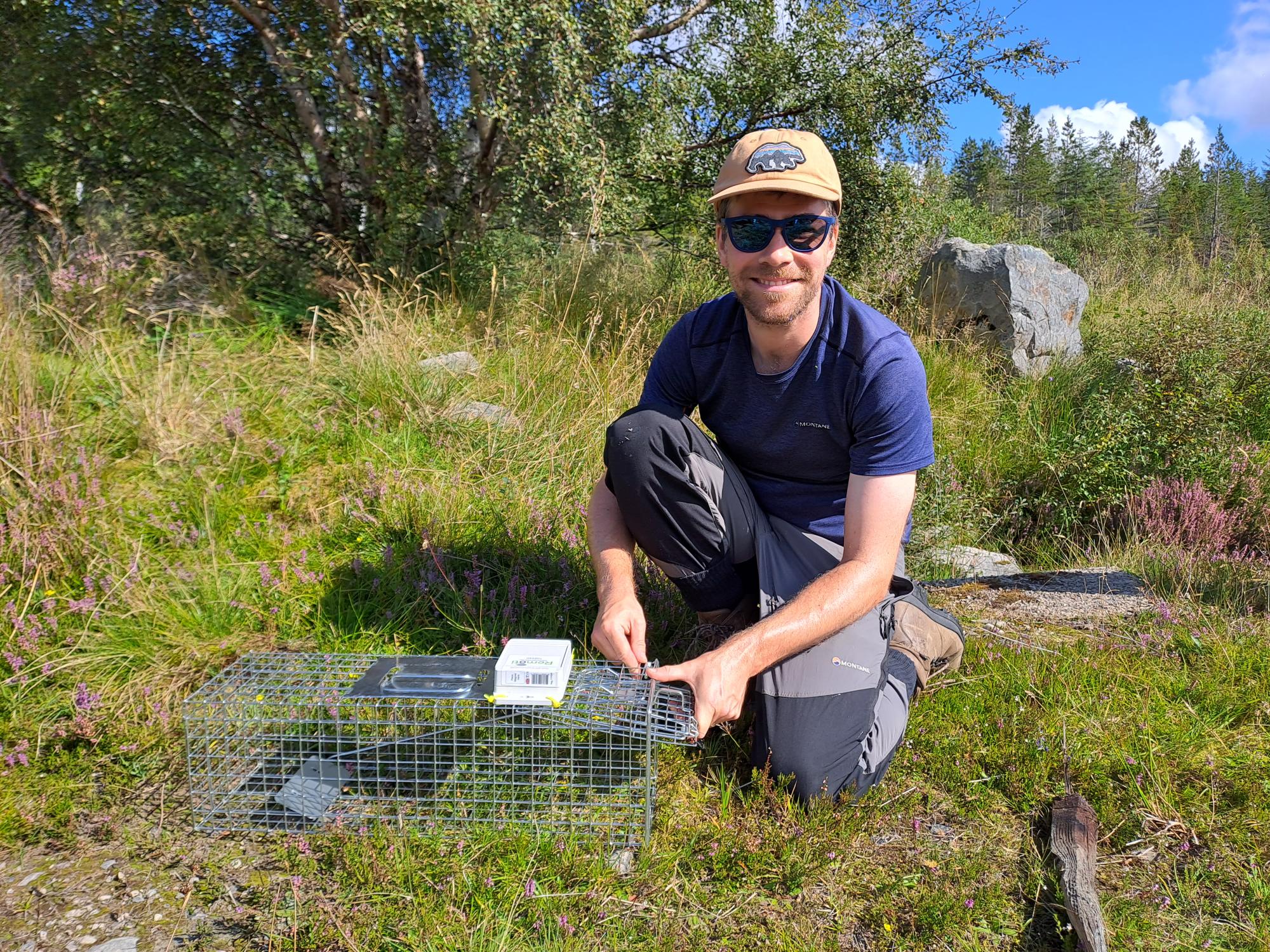 Andrew sets up a mink trap with a remoti unit attached