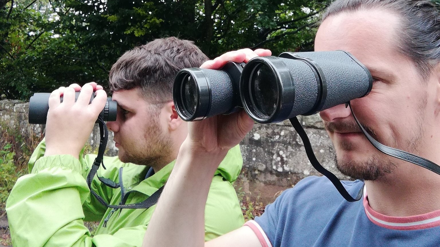 Project officers Mark and Owen surveying with binoculars