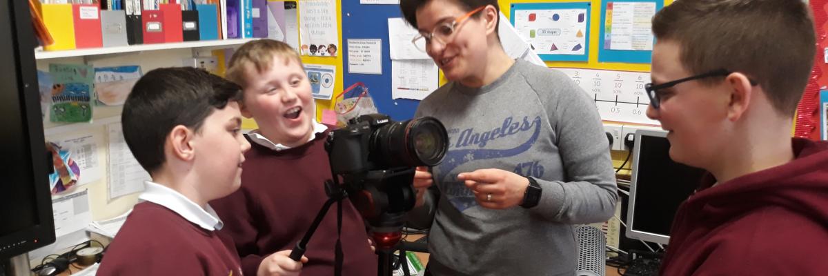 Media education staff filming with pupils