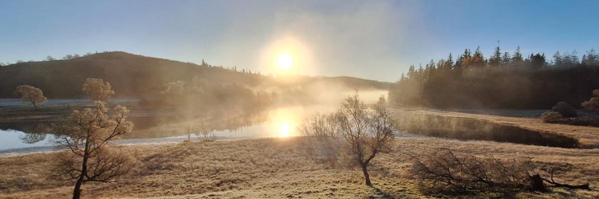 The sun low in the sky behind the River Spey